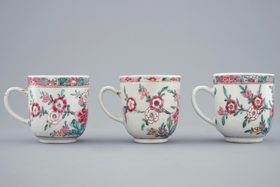 A set of three Chinese famille rose cups and saucers with bords among flowers, Yongzheng/Qianlong