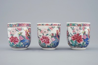 A set of three Chinese famille rose cups and saucers with bords among flowers, Yongzheng/Qianlong