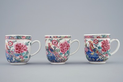 A set of three Chinese famille rose cups and saucers with bords among flowers, Yongzheng/Qianlong