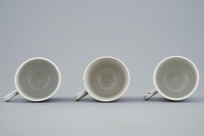 A set of three Chinese famille rose cups and saucers with bords among flowers, Yongzheng/Qianlong