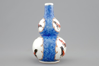 A Chinese blue ground double gourd vase with roosters, 18/19th C.
