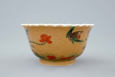 A Chinese famille verte and caf&eacute; au lait cup and saucer, Kangxi