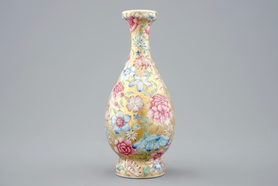 A Chinese gilt-ground famille rose millefleurs vase, 19/20th C.