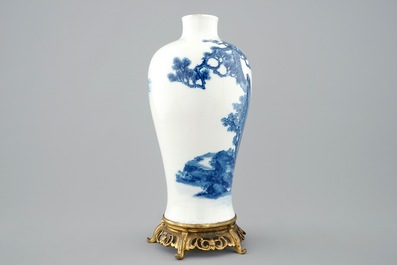 A Chinese blue and white meiping vase on gilt bronze stand, 19th C.