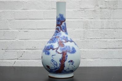 A Chinese blue and underglaze red bottle vase with cranes, 19/20th C.