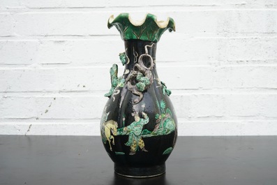 A Chinese famille noire lotus-shaped vase with applied dragons, 19th C.