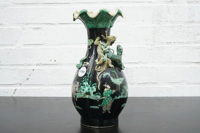 A Chinese famille noire lotus-shaped vase with applied dragons, 19th C.