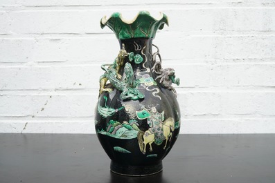 A Chinese famille noire lotus-shaped vase with applied dragons, 19th C.