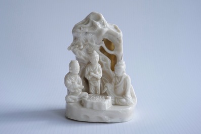 A Chinese blanc de Chine Dehua group of go-players beneath a pine tree, Kangxi