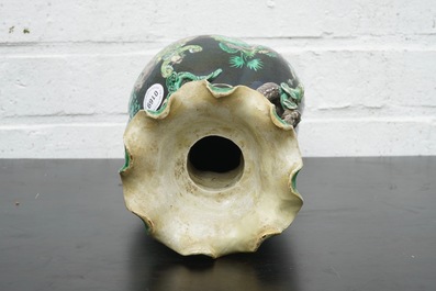 A Chinese famille noire lotus-shaped vase with applied dragons, 19th C.