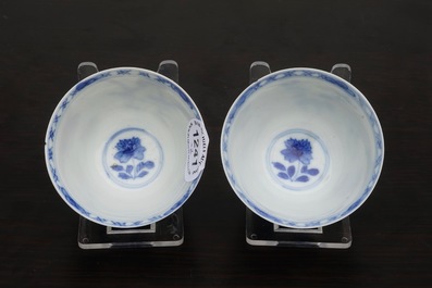 A pair of Chinese blue and white wine cups with 4 floral patterns, six-character mark, Kangxi