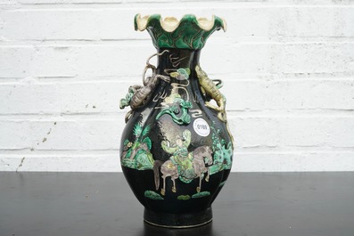 A Chinese famille noire lotus-shaped vase with applied dragons, 19th C.