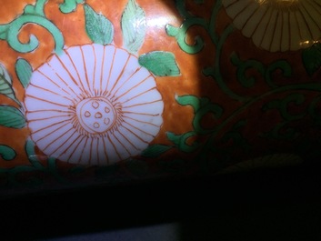 A Chinese famille verte coral-ground rouleau vase with peony scrolls, Kangxi