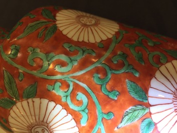 A Chinese famille verte coral-ground rouleau vase with peony scrolls, Kangxi