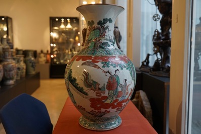 A large Chinese famille verte vase with a continuous scene and elephant handles, 19th C.