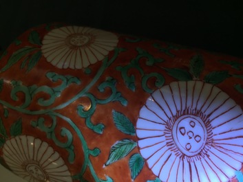 A Chinese famille verte coral-ground rouleau vase with peony scrolls, Kangxi