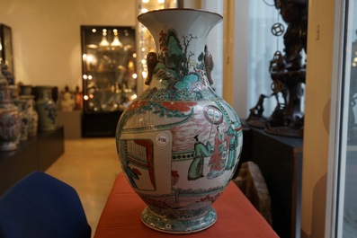 A large Chinese famille verte vase with a continuous scene and elephant handles, 19th C.