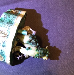 A pair of Chinese verte on biscuit foo dog joss stick holders, Kangxi