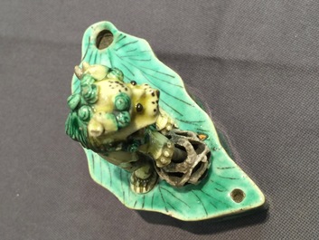 A pair of Chinese verte on biscuit foo dog joss stick holders, Kangxi