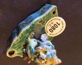 A pair of Chinese verte on biscuit foo dog joss stick holders, Kangxi