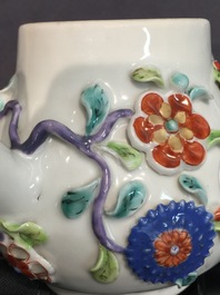 A Chinese moulded and applied famille rose teapot and cover on stand, Yongzheng, 1723-1735