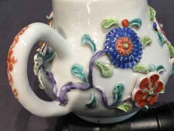 A Chinese moulded and applied famille rose teapot and cover on stand, Yongzheng, 1723-1735