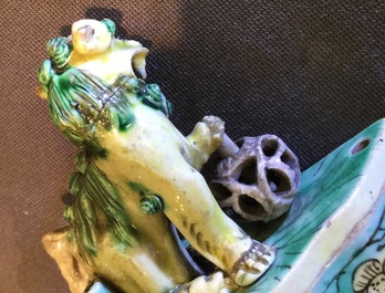 A pair of Chinese verte on biscuit foo dog joss stick holders, Kangxi