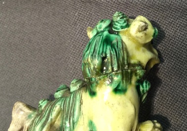 A pair of Chinese verte on biscuit foo dog joss stick holders, Kangxi