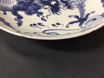 A large Chinese blue and white floral charger and two plates, Kangxi
