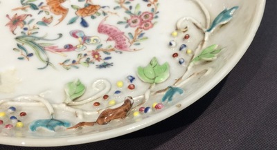 A Chinese relief-decorated famille rose cup and saucer with squirrels, Yongzheng, 1723-1735