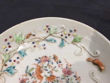 A Chinese relief-decorated famille rose cup and saucer with squirrels, Yongzheng, 1723-1735