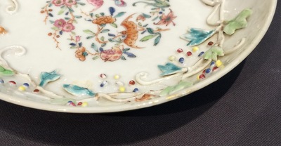 A Chinese relief-decorated famille rose cup and saucer with squirrels, Yongzheng, 1723-1735