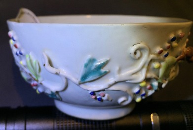 A Chinese relief-decorated famille rose cup and saucer with squirrels, Yongzheng, 1723-1735