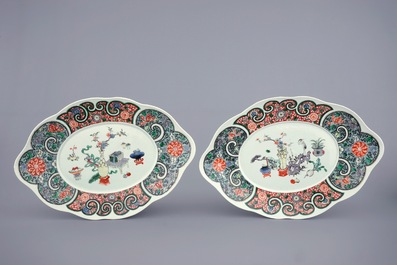 A pair of Chinese famille verte tureens and covers on stands, 19th C.