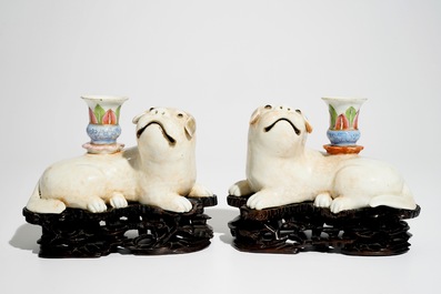 A pair of Chinese famille rose dog-shaped candle holders, 18/19th C.