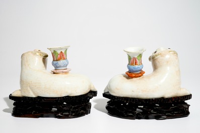 A pair of Chinese famille rose dog-shaped candle holders, 18/19th C.