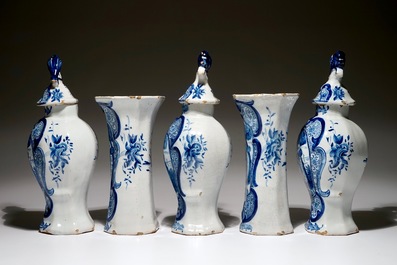 A Dutch Delft blue and white five-piece garniture with a hunter, 19th C.