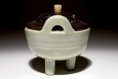 A Chinese tripod celadon censer with jade-inset wooden cover, 19th C.
