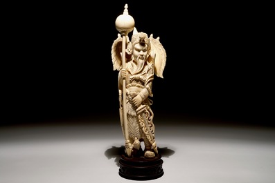 A Chinese carved ivory figure of a warrior on a wooden base, late 19th C.
