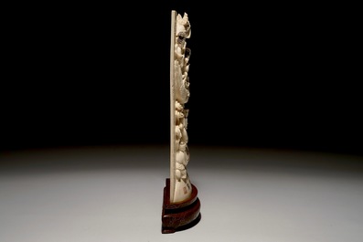 A Chinese carved ivory plaque with immortals on wooden stand, 2nd quarter 20th C.