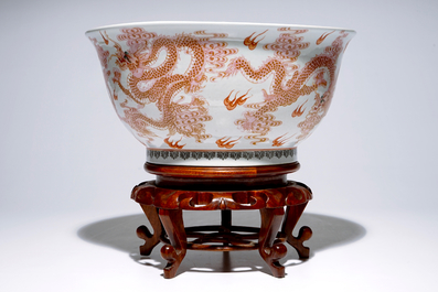 A large Chinese famille rose "dragon" bowl on a wooden stand, 20th C.
