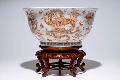 A large Chinese famille rose "dragon" bowl on a wooden stand, 20th C.