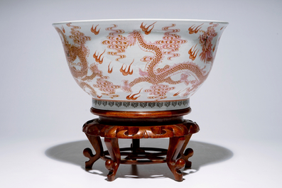 A large Chinese famille rose "dragon" bowl on a wooden stand, 20th C.