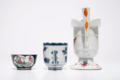 A Chinese famille rose jug, a cup and saucer and another cup with ear, 18th C.