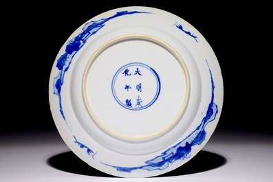 A Chinese blue and white plate with "Long Elizas" in the garden, Kangxi