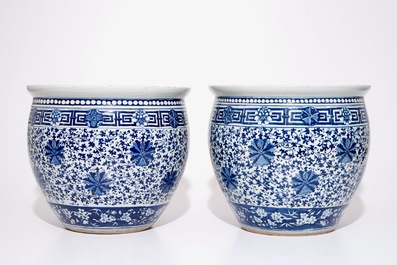 A pair of Chinese blue and white lotus scroll fishbowls, 19th C.