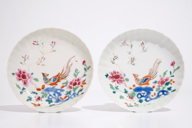 A pair of Chinese famille rose cups and saucers with peacocks, Qianlong