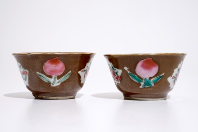 A pair of Chinese famille rose capucin ground cups and saucers, Qianlong