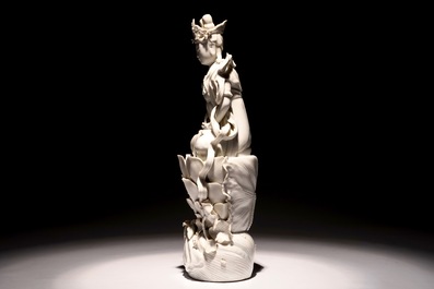 A tall Chinese Dehua blanc de Chine Guanyin seated on a lotus flower, 19/20th C.