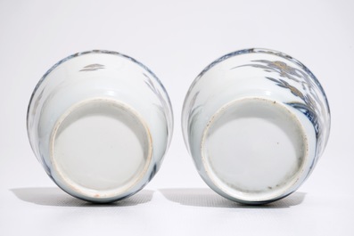 A pair of Chinese blue, white and gilt cups and saucers, Qianlong